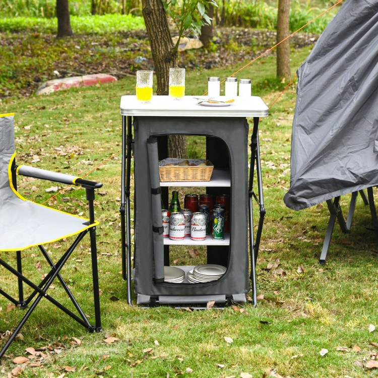 Folding camping storage cabinet with 3 shelves, waterproof oxford cloth, and spacious tabletop for outdoor use.