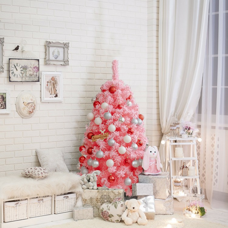 Pink Christmas tree with snow flocked PVC tips and metal stand, 4.5 ft tall, perfect for festive room decor.