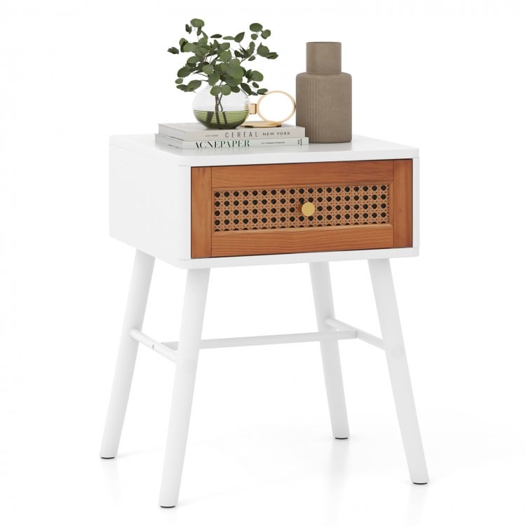 Mid-century modern rattan nightstand in white with a drawer, perfect for bedroom storage and decor.