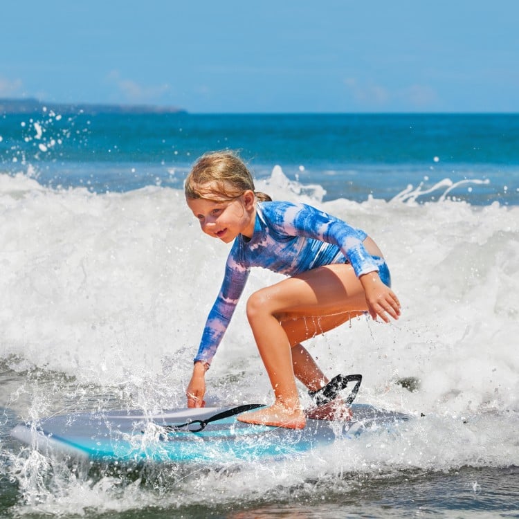 Lightweight boogie board with XPE deck and EPS core, perfect for kids riding waves at the beach.
