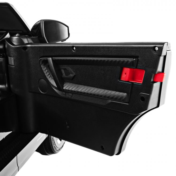 Close-up of the black door of a 12V kids ride-on car featuring a lockable design and realistic details.