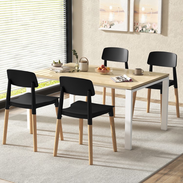 Set of 4 black ergonomic dining side chairs with beech legs, ideal for dining rooms and cafes.
