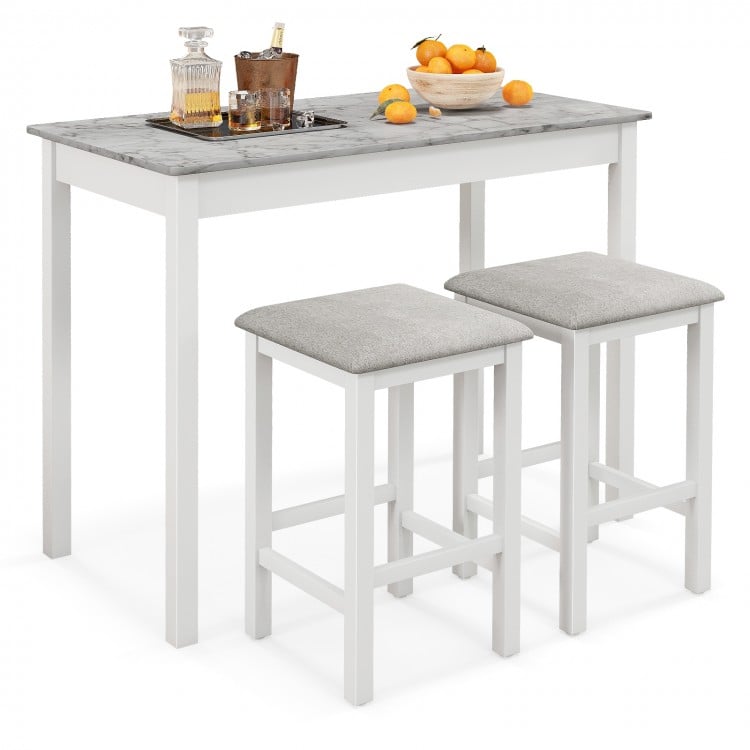 3-piece bar table set with faux marble top, white legs, and 2 padded stools for stylish dining or breakfast at home.