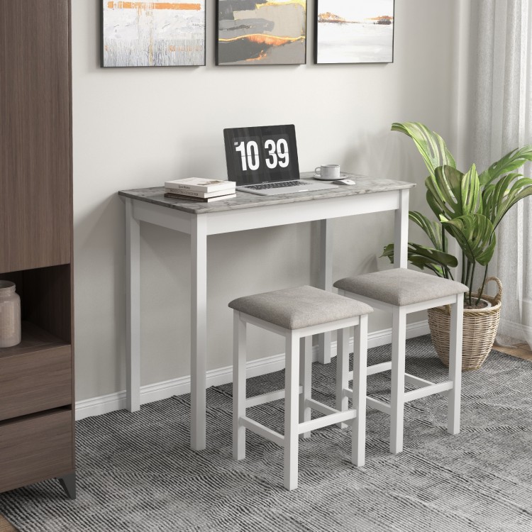 Bar table set with faux marble top and two padded stools, perfect for dining or breakfast in a compact space.