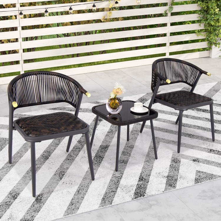 Two black and brown patio chairs with a glass-top coffee table, ideal for backyard and poolside relaxation.