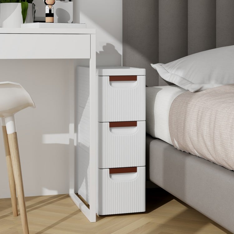 Narrow 3-drawer rolling organizer unit in white with fluted surface, perfect for small spaces like bathrooms or offices.