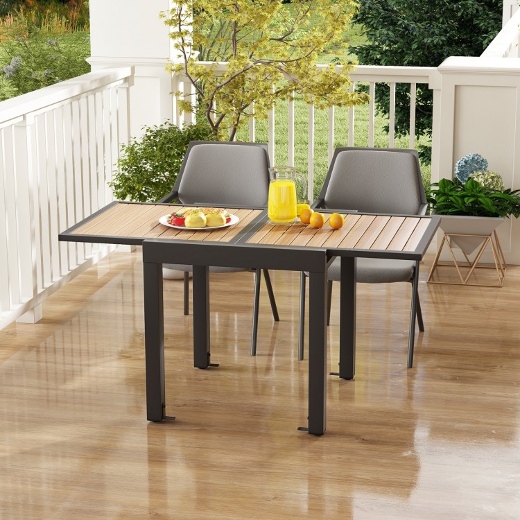 Extendable patio table with slatted wood-like top, accommodating 4-6 people, perfect for outdoor gatherings.