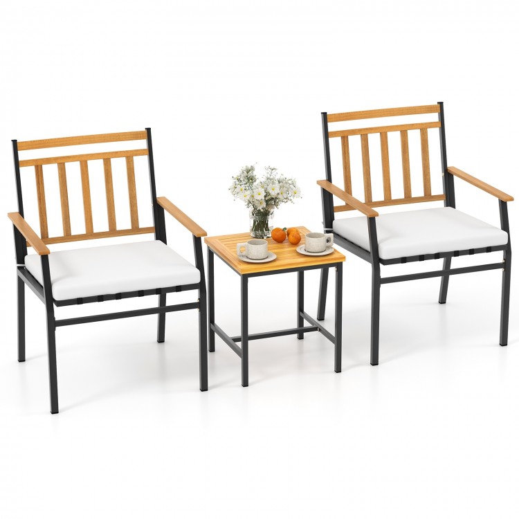 Two ergonomic chairs with white cushions and acacia wood armrests, paired with a matching table for outdoor relaxation.
