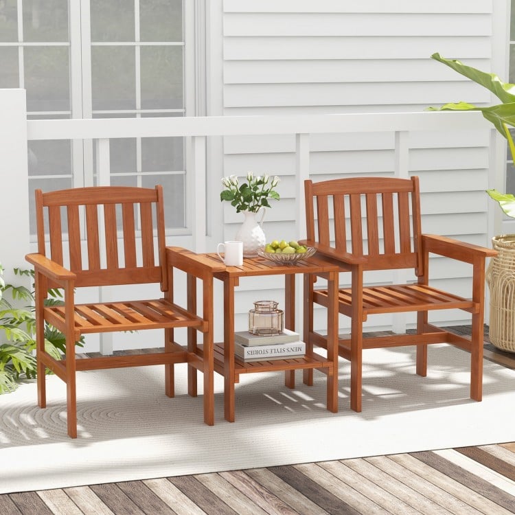 Two wooden chairs with a bistro table, featuring umbrella holes, perfect for outdoor patios and gardens.