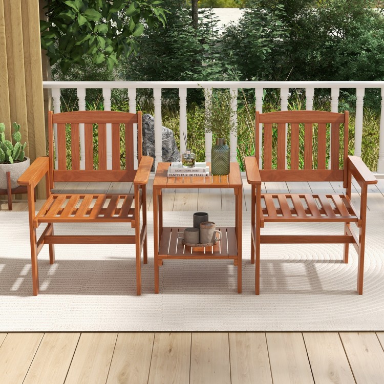 Two wooden chairs with slatted backs and a bistro table featuring umbrella holes, perfect for outdoor relaxation.