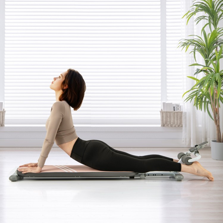 Multifunctional sit-up bench in pink, featuring adjustable angles and a high-density cushion for comfortable workouts.
