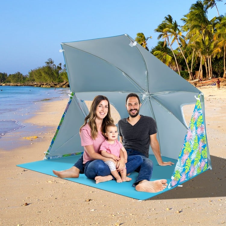 Family enjoying the UPF50+ beach umbrella tent in blue, providing sun protection and comfort on the sandy beach.