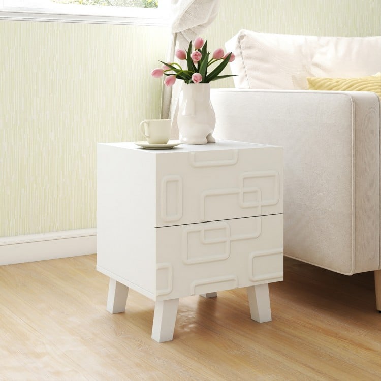 Modern white nightstand with 3D geometric patterns, featuring two drawers, perfect for bedside storage and decor.