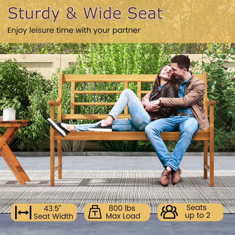 Patio acacia wood bench with curved armrests, slatted seat, and backrest, seats 2, ideal for backyard or garden use.