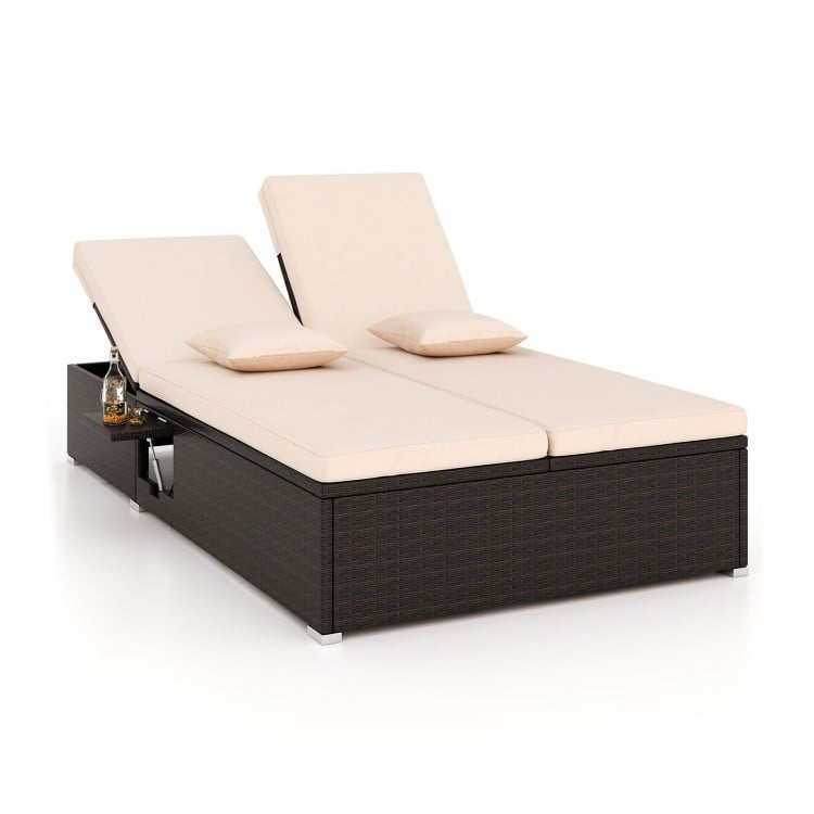 Patio double chaise lounge with beige cushions, adjustable backrests, and folding side trays for poolside relaxation.