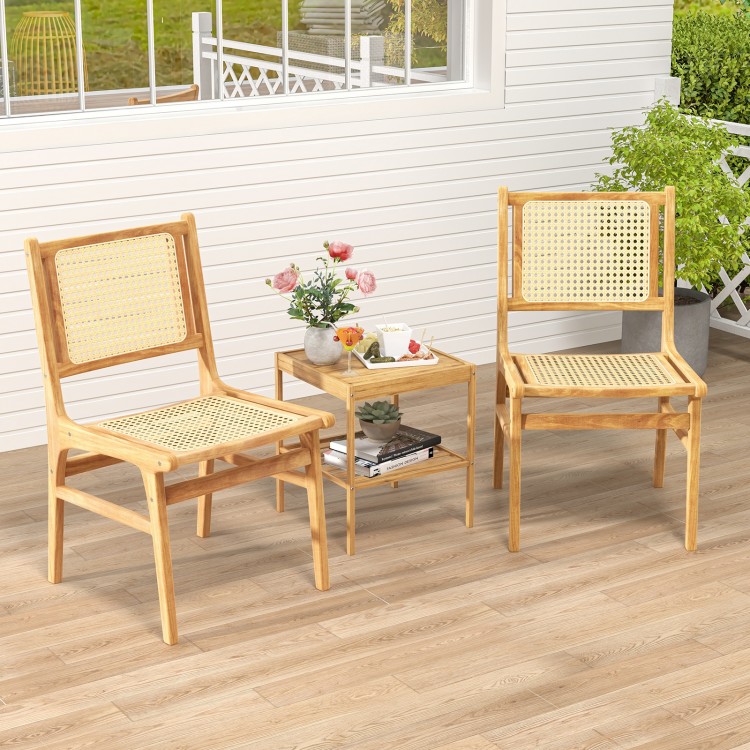 Rattan dining chairs with natural cane backrest and teak wood frame, perfect for stylish indoor or outdoor settings.