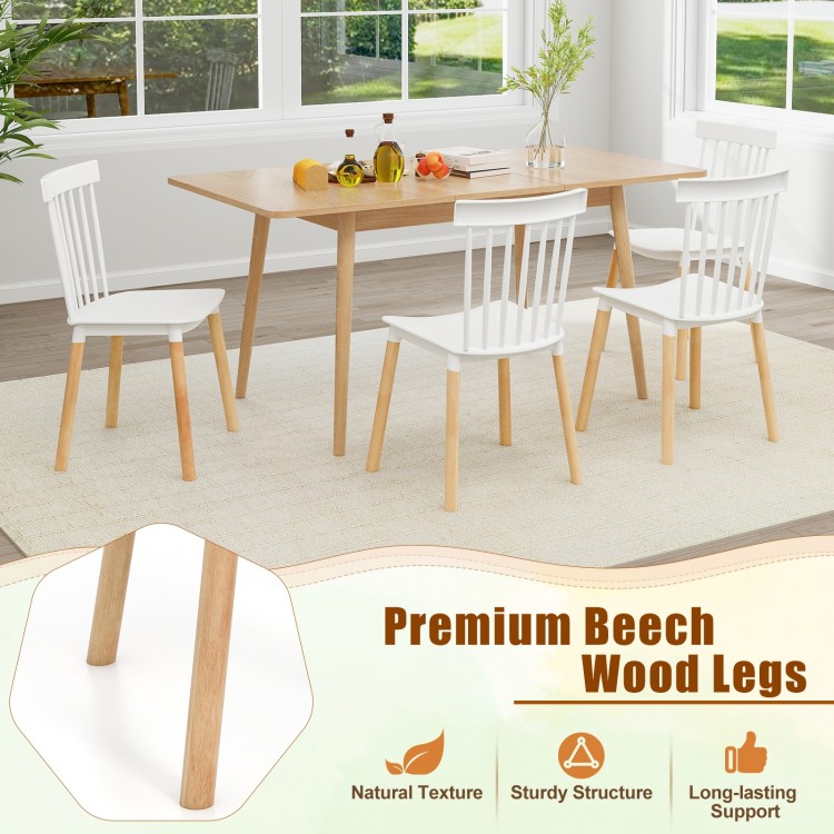 Set of 4 white Windsor dining chairs with spindle backs and curved seats, featuring sturdy beech wood legs for.