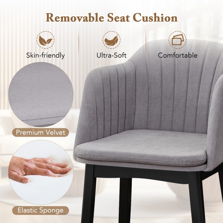 Curved backrest of a grey upholstered velvet dining chair with a removable cushion, ideal for dining and relaxation.