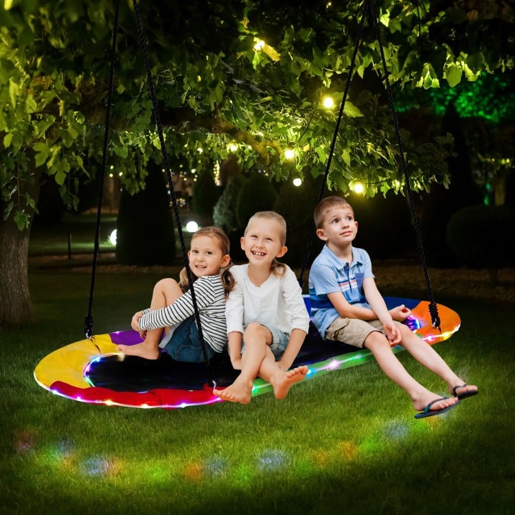 Colorful 60-inch saucer swing with LED lights, designed for kids and adults, perfect for outdoor nighttime fun.