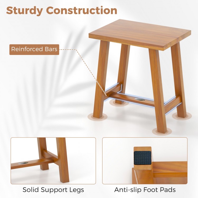 Teak shower stool with solid support legs and anti-slip foot pads, ideal for bathrooms and spa use.
