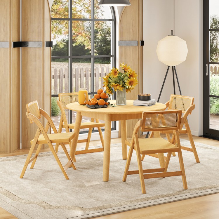 Bright and inviting dining scene featuring a round table with natural rattan cane folding chairs, perfect for stylish.