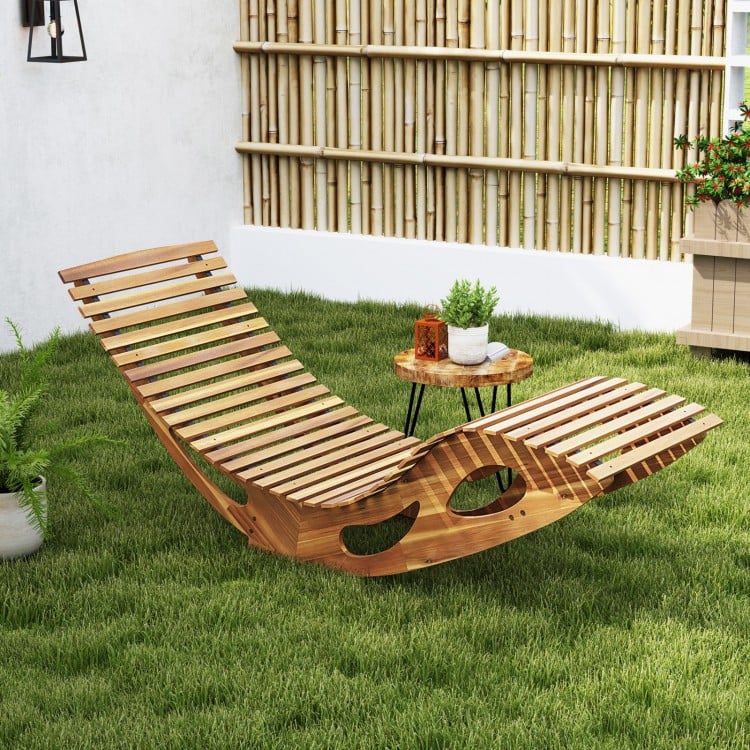 Acacia wood patio rocking sun lounger with ergonomic curved seat, perfect for poolside or backyard relaxation.