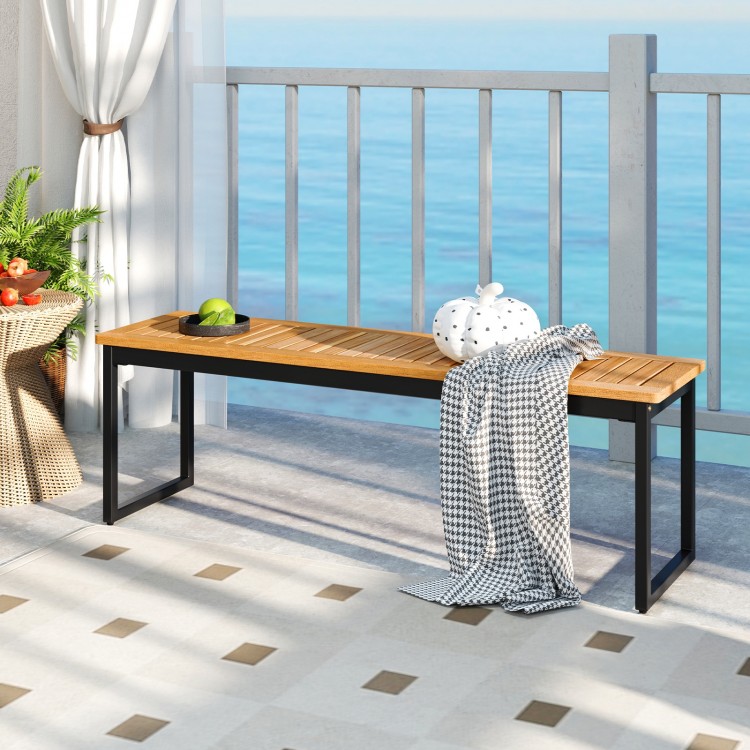 Backless patio dining bench with slatted acacia wood seat and sturdy metal legs, ideal for indoor and outdoor use.