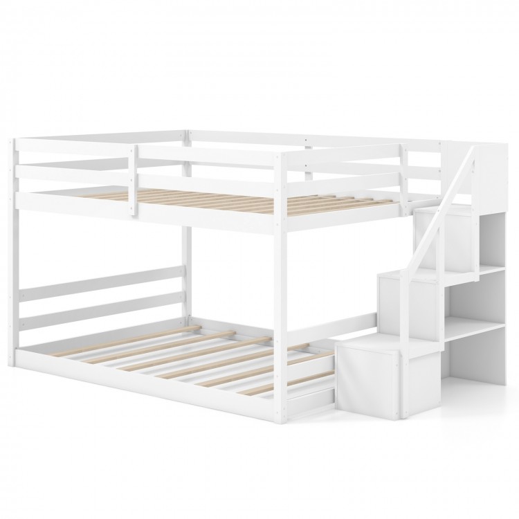 Low profile solid wood full over full bunk bed in white with storage stairs and guardrails for kids' rooms.