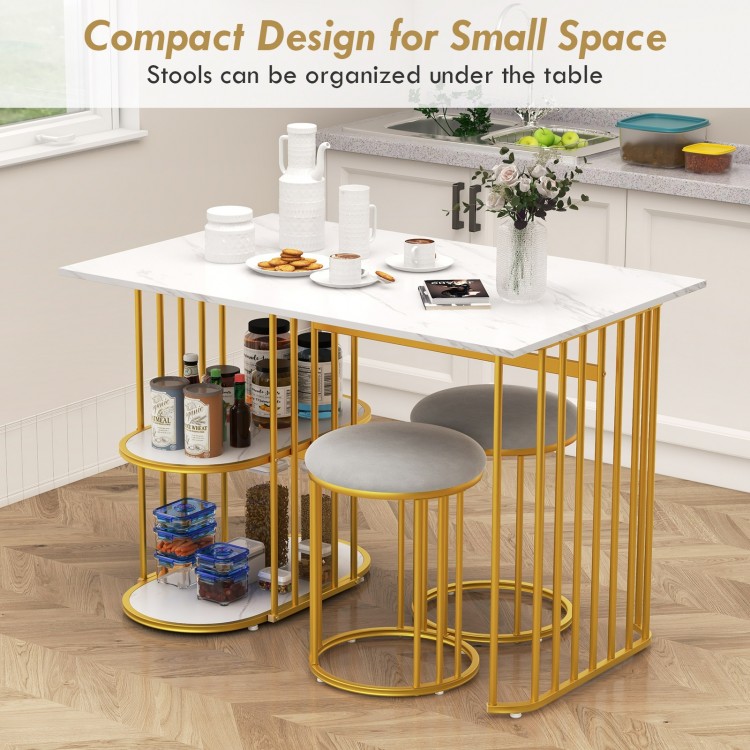 Rectangular dining table with faux marble surface, gold metal frame, and two upholstered stools for small space dining.