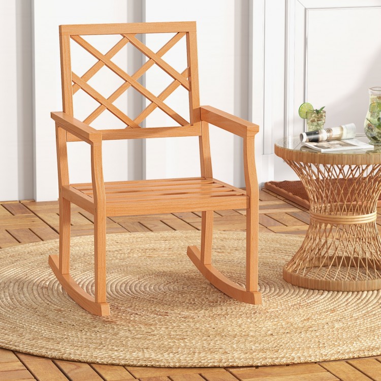 Teak wood rocking chair with slatted seat and backrest, perfect for outdoor relaxation on the porch or patio.