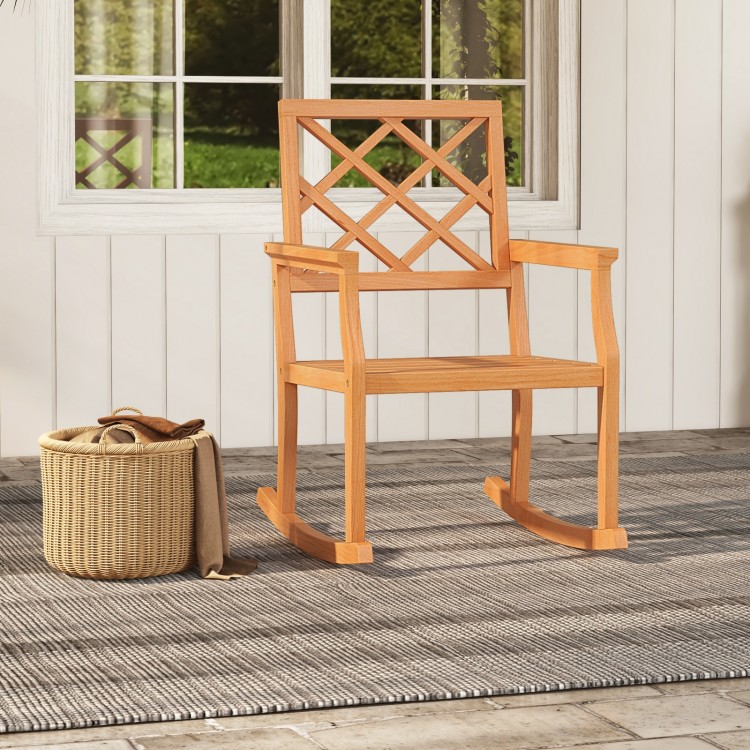Teak wood rocking chair with backrest and slatted seat, perfect for outdoor relaxation on the porch or patio.