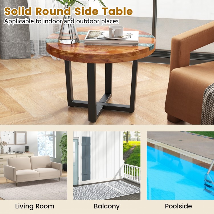 Solid round teak wood end table with epoxy resin top, featuring X-shaped legs, ideal for indoor and outdoor use.