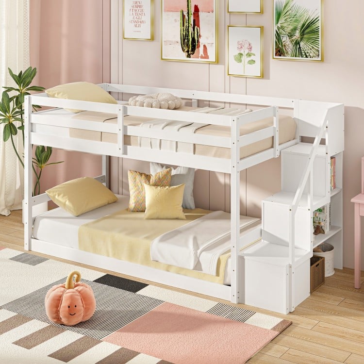 Twin over twin low bunk bed in white, showcasing the integrated storage stairs and safety guardrails for easy access.