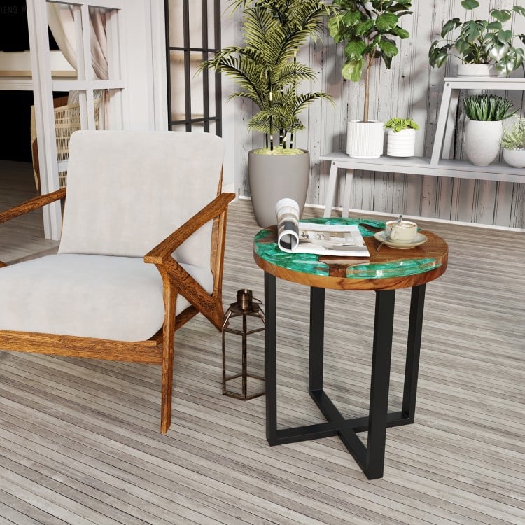 Round teak wood end table with epoxy resin top, featuring X-shaped legs, ideal for outdoor use on patio or balcony.