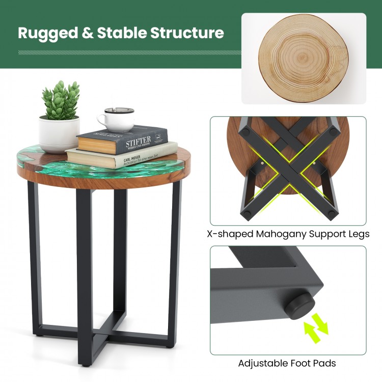 Round teak wood outdoor end table with epoxy resin top, featuring X-shaped mahogany legs and adjustable foot pads for.