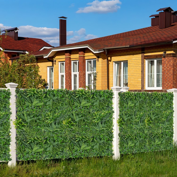 Artificial hedge boxwood panels featuring diverse leaves, ideal for privacy screens and green wall backdrops outdoors.