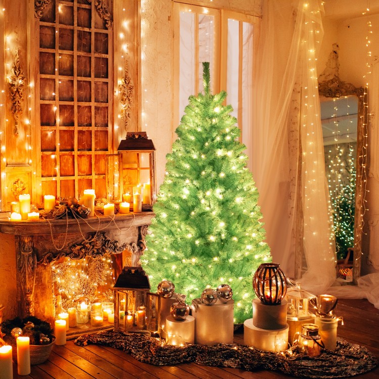 6 FT blue artificial Christmas tree with warm white LED lights, set in a cozy decorated room for festive ambiance.