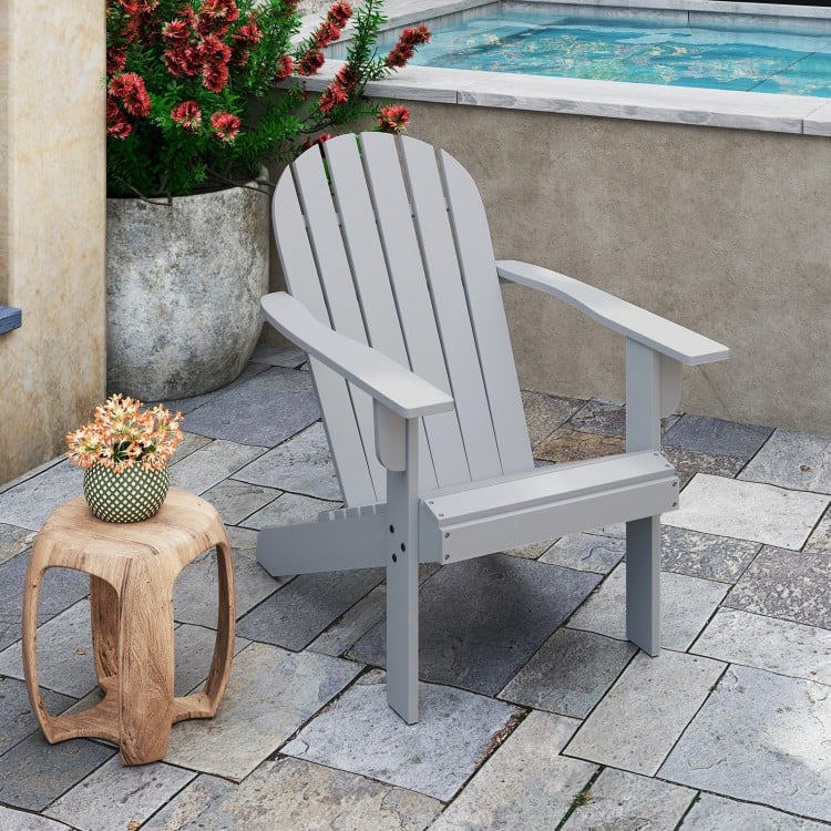 Gray acacia wood Adirondack chair with inclined seat and wide armrests, perfect for backyard or poolside relaxation.