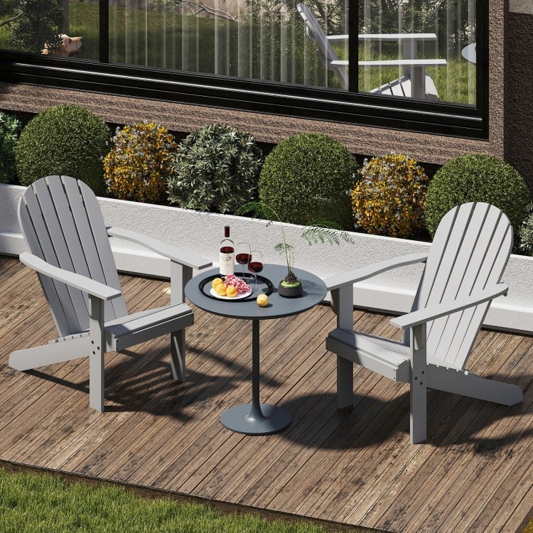 Gray acacia wood Adirondack chairs with inclined seats and wide armrests, perfect for backyard relaxation.