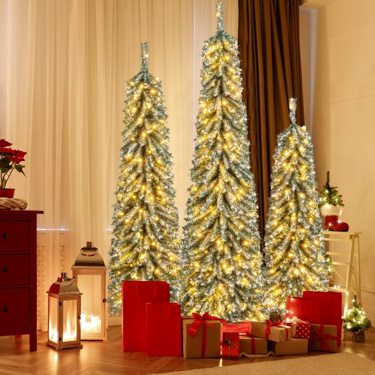 Three artificial Christmas trees, 4/5/6 feet tall, with realistic snow and warm LED lights, perfect for festive.