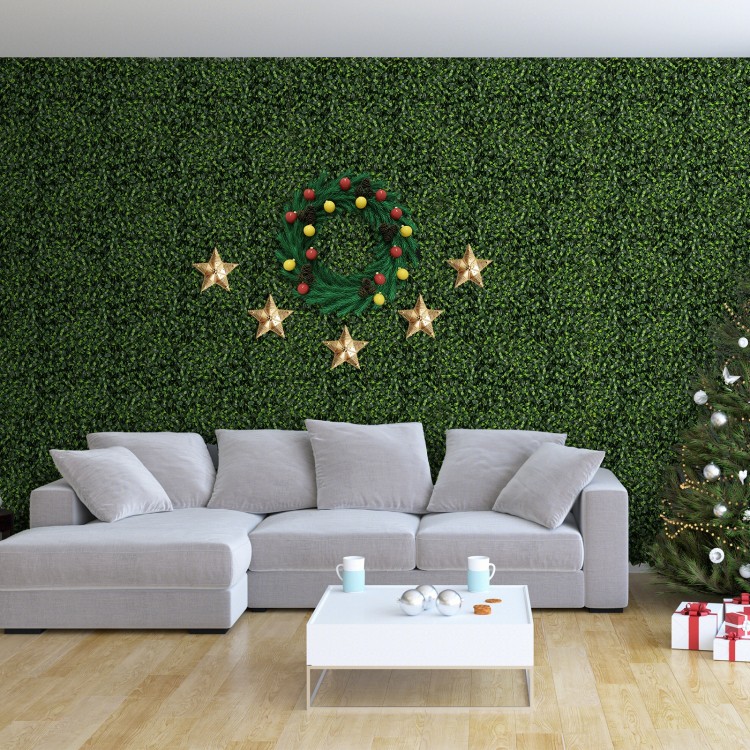 Artificial topiary grass panels in a living room setting, featuring vibrant green gardenia leaves for indoor decor.