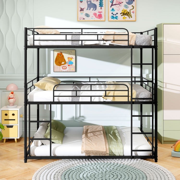 Metal triple bunk bed in black with safety guardrails and two ladders, perfect for space-saving in smaller rooms.