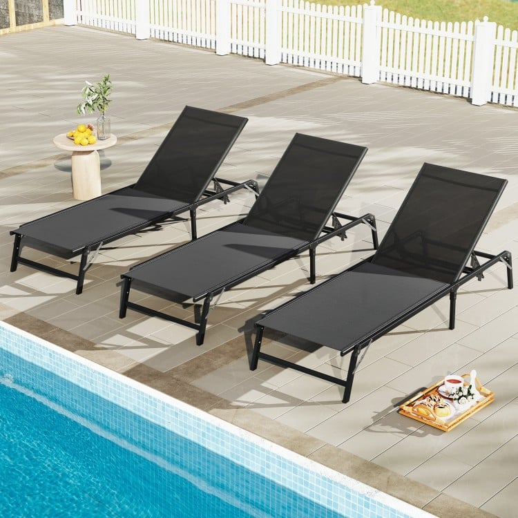 Set of 2 black foldable chaise lounge chairs with adjustable backrests, perfect for poolside relaxation.