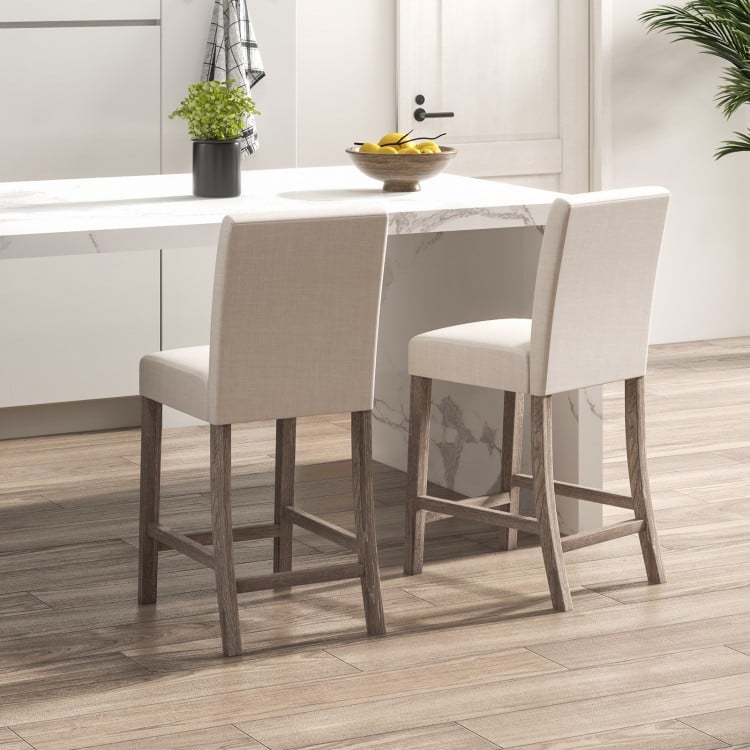 Counter height bar stools set of 2 in beige with padded seats and ergonomic backrest for kitchen or dining use.