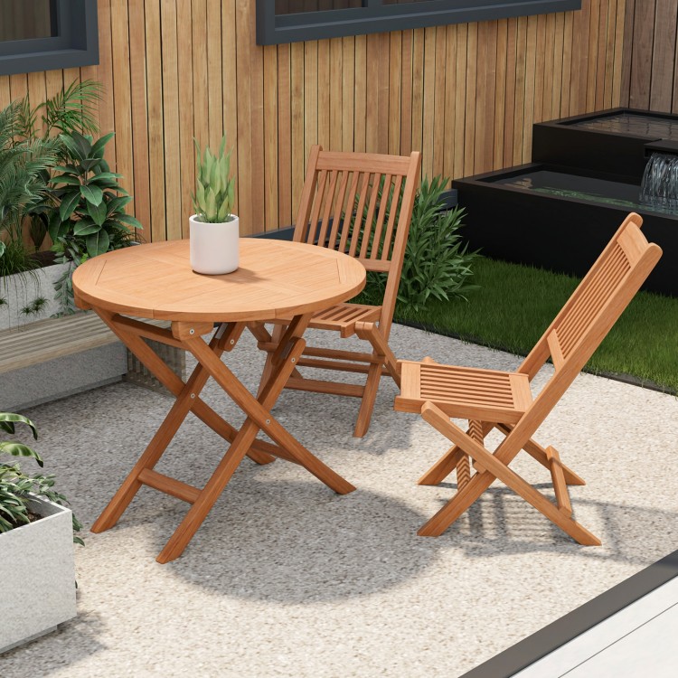 Outdoor bistro set featuring a round teak wood table and slatted chairs, perfect for backyard or poolside use.