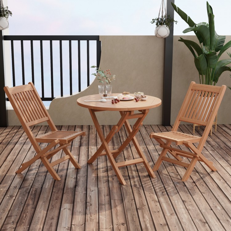 Outdoor bistro set featuring a slatted teak wood tabletop and folding chairs, perfect for backyard dining.