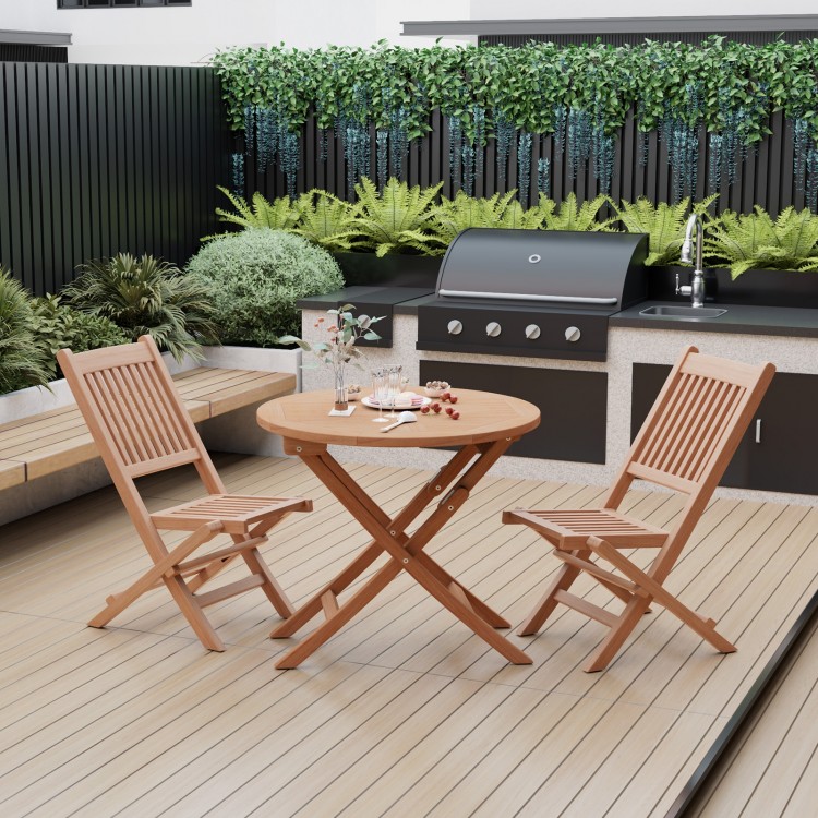 Teak wood folding chairs with slatted design and X-shaped structure, ideal for elegant outdoor dining in the backyard.