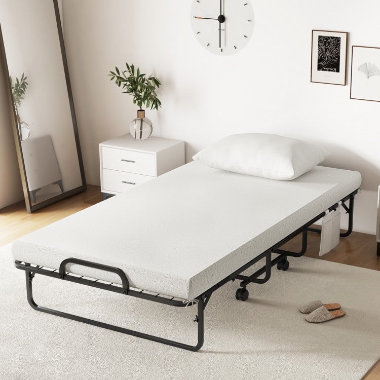 Twin size rollaway guest folding bed with a 4-inch soft-padded mattress, sturdy frame, and included memory foam pillow.