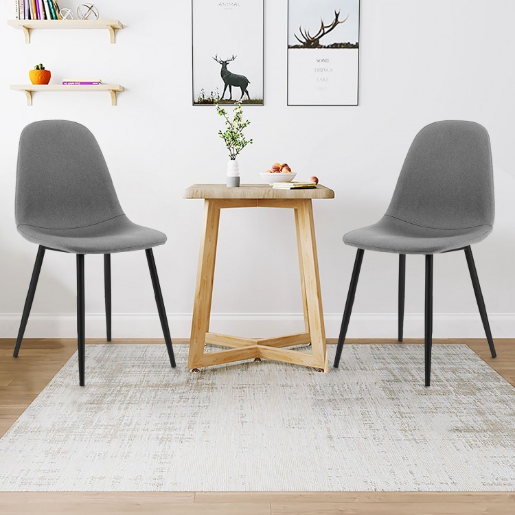 Close-up of gray dining chair with foam upholstery and black metal legs, showcasing the ergonomic backrest for enhanced.