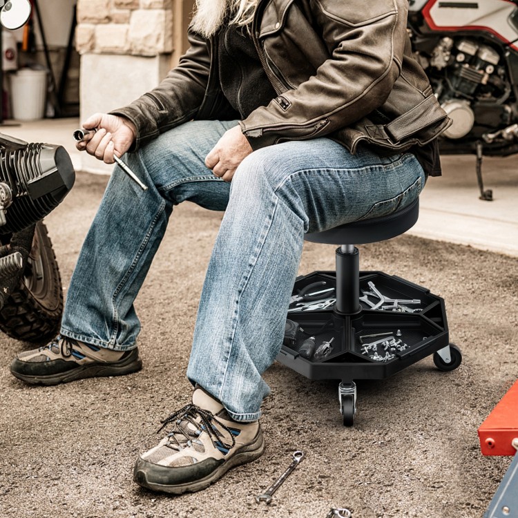 Pneumatic rolling mechanic stool with padded seat, adjustable height, and large tool tray for convenience and comfort.